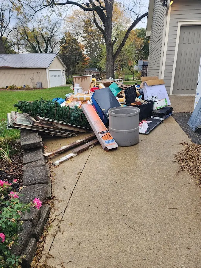 Dumpster being loaded with debris for 30 Yard Dumpster Rental in Bensley
